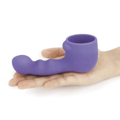 Hand holding Le Wand Ripple Petite silicone attachment to show compact palm-sized scale
