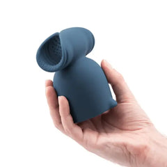 Hand holding Le Wand Stroke attachment tilted to reveal honeycomb-textured interior chamber