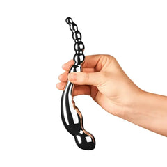 Hand holding Le Wand Swerve stainless steel dildo to show size and dual-end design