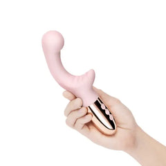 Hand holding Le Wand XO blush pink rabbit vibrator showing rose gold handle