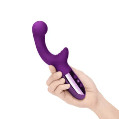 Hand holding Le Wand XO dark cherry vibrator showing compact ergonomic size