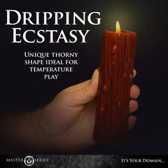 Hand holding lit Thorn Drip Candle in low light highlighting unique thorny sculptural shape