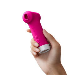 Hand holding the Lovense Fizz clitoral vibrator to demonstrate its compact ergonomic grip size
