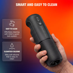 Hand holding Orbit stroker demonstrating compact size with quick-lock CleanTech silicone sleeve