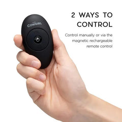 Hand holding the oval black magnetic rechargeable remote control for the Cowgirl Saddle