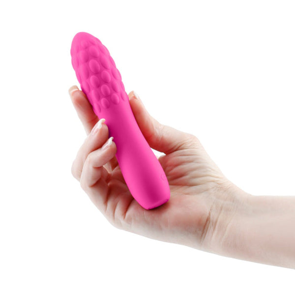 Hand holding pink INYA Rita silicone vibrator showing textured bubble tip and slim handle