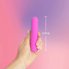 Hand holding pink plusOne super bullet against gradient background with 4.75-inch length measurement shown