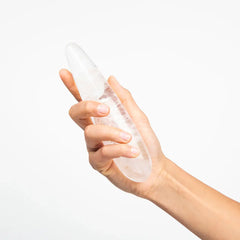 Hand holding the Prism Crystal Pleasure Wand upright, showing smooth curved body and natural clarity