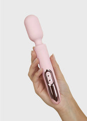 Hand holding Prowand wand vibrator showing ergonomic grip and rose-gold button panel