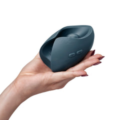 Hand holding Pulse Duo couples massager to show compact palm-sized scale, slate blue