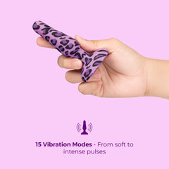 Hand holding purple leopard-print anal plug, illustrating its 15 vibration modes and petite size