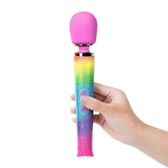 Hand holding rainbow glitter wand massager, pressing the pink control button