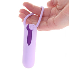 Hand holding the rechargeable bullet vibrator with silicone ring from the kit