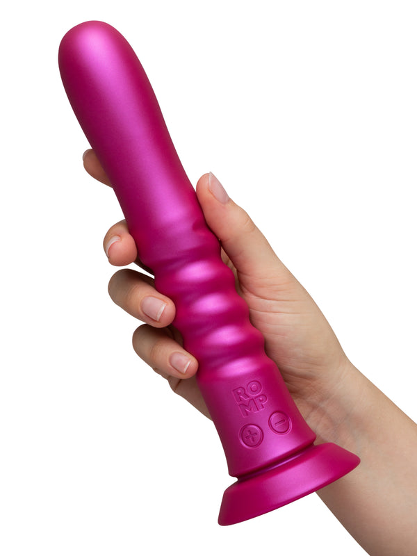Hand holding ROMP Jiggle upright, displaying smooth tapered tip and ridged midsection
