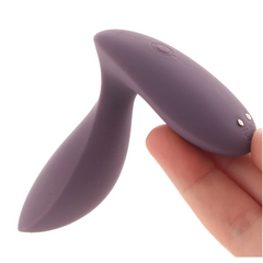 Hand holding the Satisfyer Power Plug showing magnetic charging points on the base