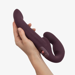 Hand holding Share Vibe Pro plum double dildo showing full scale and control button