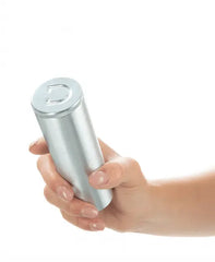 Hand holding the silver aluminium travel canister included with the Doxy Ribbed Butt Plug
