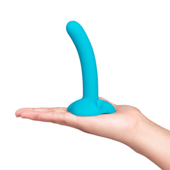 Hand holding small teal silicone dildo with suction-cup base, demonstrating compact beginner size