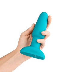 Hand holding teal b-Vibe Rimming Plug 2 to show size and ergonomic silicone build