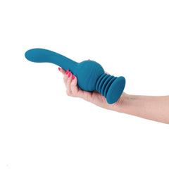 Hand holding teal NS Novelties Earthquake vibrator, showing curved shaft and textured grip base