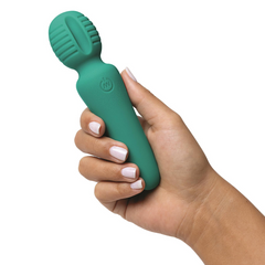 Hand holding the teal petite wand vibrator, showing compact palm-friendly size and smooth handle