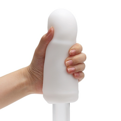 Hand holding the Tenga 3DX Flow upright showing smooth rounded top opening