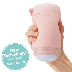 Hand holding Tenga PUFFY demonstrating palm-sized fit; labeled silky smooth and incredibly soft