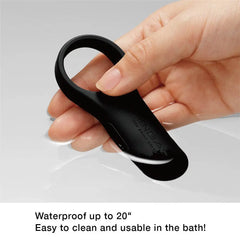 Hand holding Tenga SVR+ black ring above water surface, waterproof up to 20 inches deep