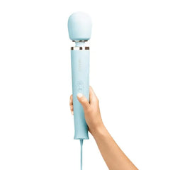 Hand holding upright Le Wand sky blue wand massager showing full size and ergonomic handle grip