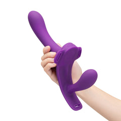 Hand holding upright purple dual-ended dildo to demonstrate flexibility and soft silicone construction