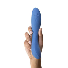 Hand holding the We-Vibe Rave 2 blue vibrator, showing size and button controls