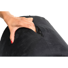 Hand pressing into soft black velvet outer cover of Love Toy Cushion showing firm foam support