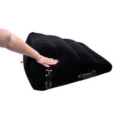Hand pressing top surface of Pivot ramp demonstrating soft, cushioned microvelvet texture