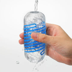 Hand rinsing clear Tenga Spinner DX 01 Drops sleeve under running water illustrating reusable design