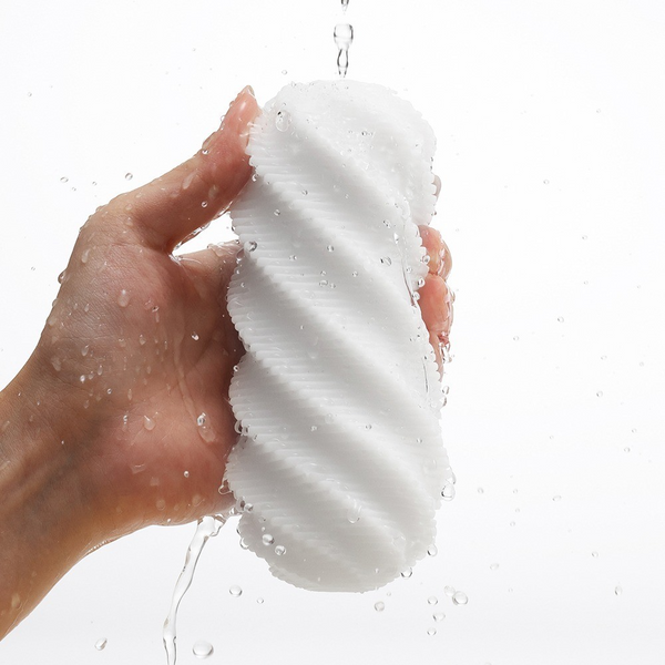 Hand rinsing the white spiral sleeve under running water, demonstrating easy cleaning