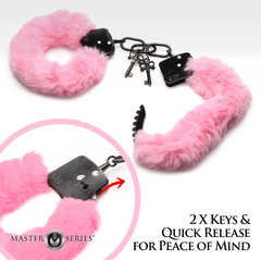 Close-up of handcuff locking mechanism with two keys and quick-release feature