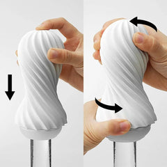 Hands demonstrating squeeze and twist motion on white Tenga Flex flexible masturbator sleeve
