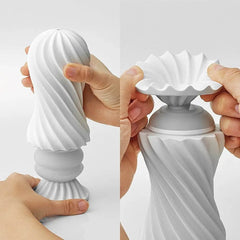 Hands fitting Tenga Flex spiral sleeve onto base, showing two-part reusable assembly