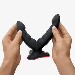 Hands gently flexing the Ryde grinding dildo to demonstrate its soft, bendable silicone material