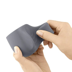 Hands stretching the flexible grey silicone Loop attachment to demonstrate its soft, pliable material