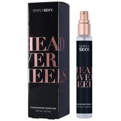 Head Over Heels pheromone perfume beside dark box with rose gold foil lettering, front view