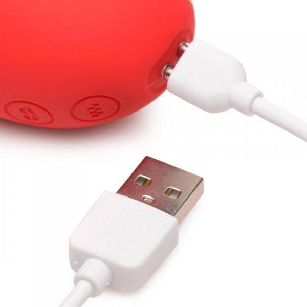 Close-up of the Heart's Desire magnetic USB charging cable connected to the two charging pins on the device