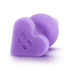 Close-up of heart-shaped base engraved with Do Me Now on purple silicone anal plug