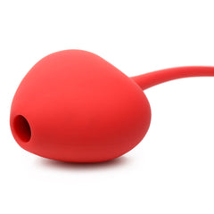 Close-up of heart-shaped red silicone suction cup with small circular opening on Shegasm stimulator