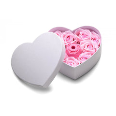 Heart-shaped white gift box lid open revealing pink rose soap flowers and rose vibrator