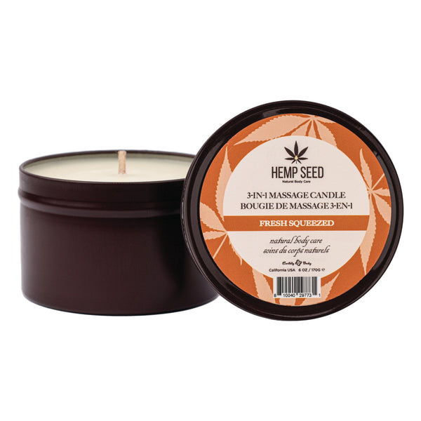Hemp Seed Fresh Squeezed massage candle in open dark tin showing white wax and wick