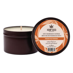 Hemp Seed Fresh Squeezed massage candle in open dark tin showing white wax and wick