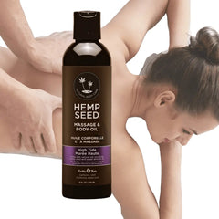 Hemp Seed Massage Oil bottle displayed beside a person receiving a back massage