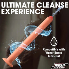 Hosed silicone enema hose shown upright with water spray, compatible with water-based lubricant
