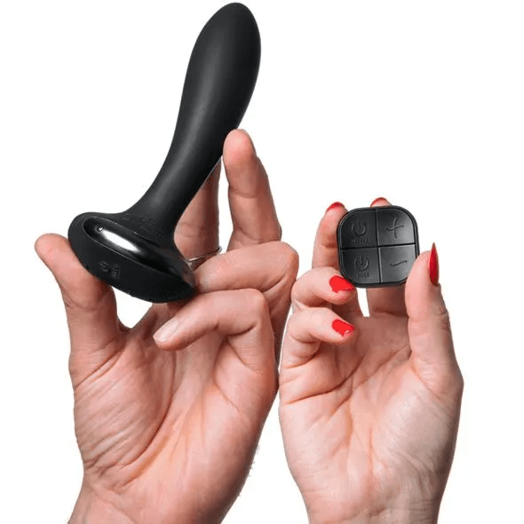 men holding black anal plug